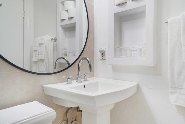 235 Sunrise Ave Unit 3225, Palm Beach, FL 33480 - bathroom with tile walls and backsplash