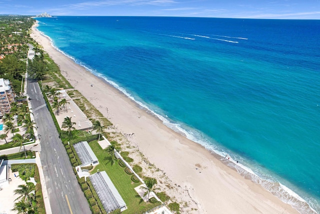 drone / aerial view with a water view and a view of the beach