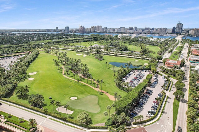 bird's eye view featuring view of golf course, a water view, and a city view