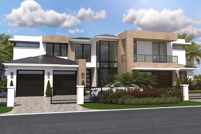 contemporary home featuring decorative driveway, a standing seam roof, fence, metal roof, and a garage