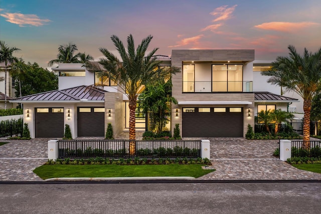 191 W Coconut Palm Rd, Boca Raton, FL 33432 - contemporary house with a standing seam roof, decorative driveway, a balcony, and metal roof
