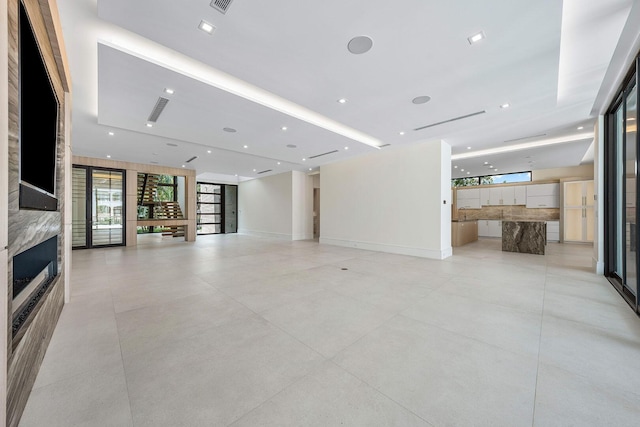 191 W Coconut Palm Rd, Boca Raton, FL 33432 - unfurnished living room with a fireplace and baseboards