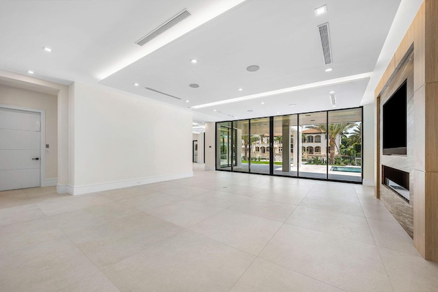 191 W Coconut Palm Rd, Boca Raton, FL 33432 - unfurnished living room featuring a fireplace, expansive windows, light tile patterned floors, baseboards, and recessed lighting