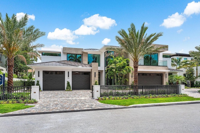 191 W Coconut Palm Rd, Boca Raton, FL 33432 - modern home featuring a standing seam roof, decorative driveway, a garage, and metal roof