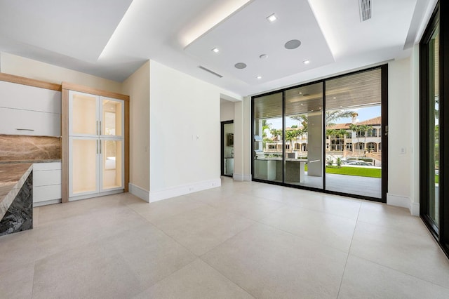 191 W Coconut Palm Rd, Boca Raton, FL 33432 - unfurnished room with a tray ceiling, baseboards, and recessed lighting