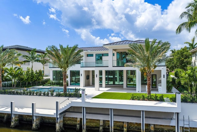 191 W Coconut Palm Rd, Boca Raton, FL 33432 - back of house featuring a fenced front yard, a standing seam roof, and a balcony