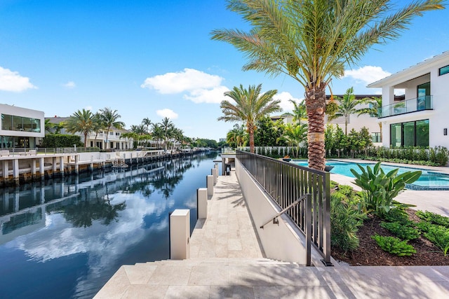 191 W Coconut Palm Rd, Boca Raton, FL 33432 - dock area featuring a water view and an outdoor pool