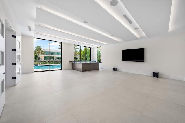 191 W Coconut Palm Rd, Boca Raton, FL 33432 - unfurnished living room featuring baseboards and light tile patterned flooring