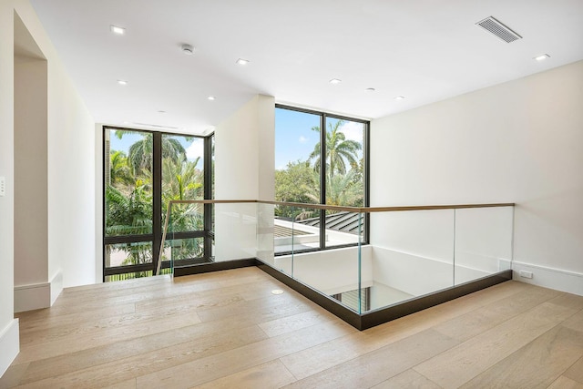 191 W Coconut Palm Rd, Boca Raton, FL 33432 - unfurnished room featuring a wall of windows, wood-type flooring, a smoke detector, and recessed lighting