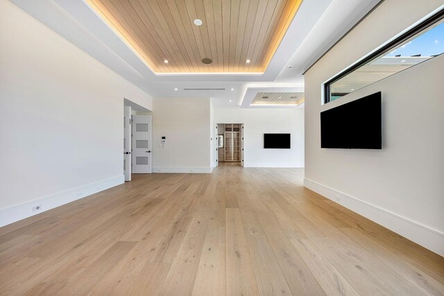 191 W Coconut Palm Rd, Boca Raton, FL 33432 - unfurnished living room with a tray ceiling, light wood-style floors, recessed lighting, wood ceiling, and baseboards