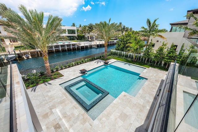 191 W Coconut Palm Rd, Boca Raton, FL 33432 - view of swimming pool featuring a water view, a pool with connected hot tub, a patio, and a fenced backyard