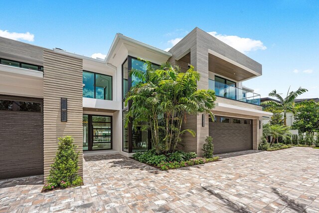 191 W Coconut Palm Rd, Boca Raton, FL 33432 - modern home with a balcony, a garage, and driveway