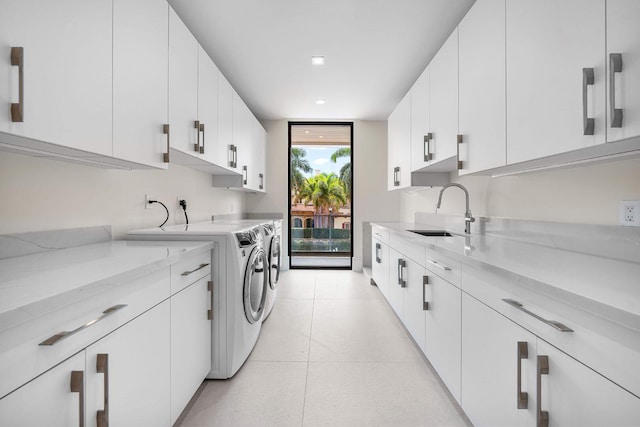 191 W Coconut Palm Rd, Boca Raton, FL 33432 - laundry area featuring washer and dryer, cabinet space, and light tile patterned floors