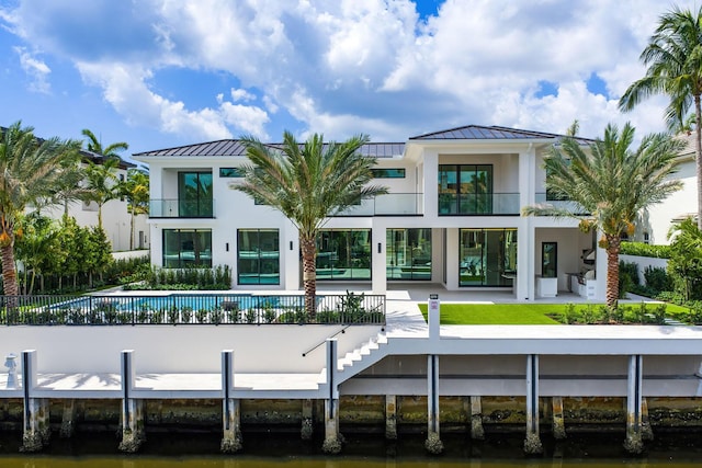 191 W Coconut Palm Rd, Boca Raton, FL 33432 - rear view of property featuring a standing seam roof, a balcony, and metal roof