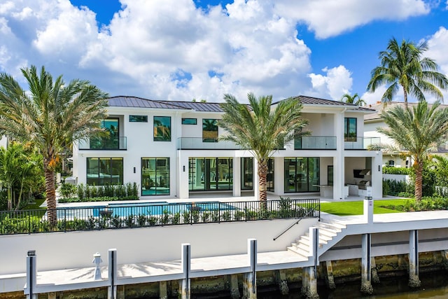 191 W Coconut Palm Rd, Boca Raton, FL 33432 - back of house with a standing seam roof, metal roof, stucco siding, and a balcony