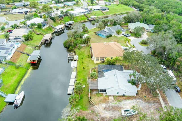 drone / aerial view featuring a water view and a residential view