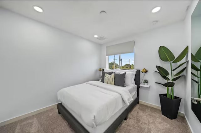 bedroom featuring recessed lighting, light colored carpet, and baseboards