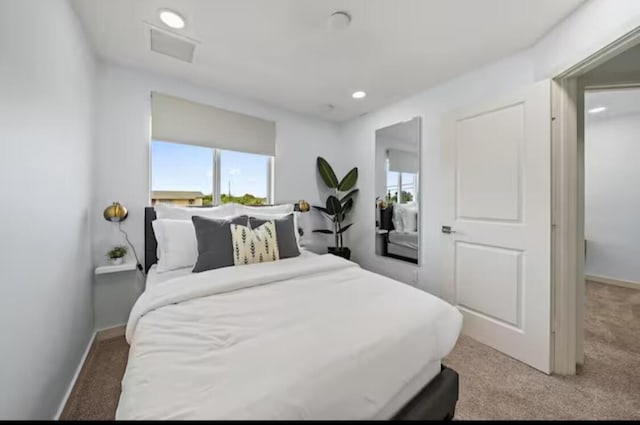 bedroom with recessed lighting, light carpet, and baseboards