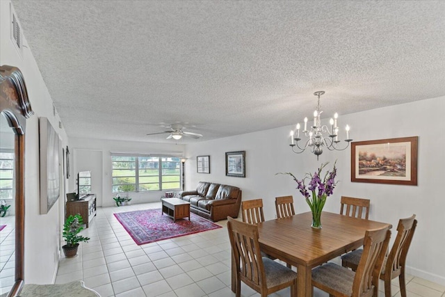 dining room featuring light tile patterned floors, visible vents, a textured ceiling, and ceiling fan with notable chandelier