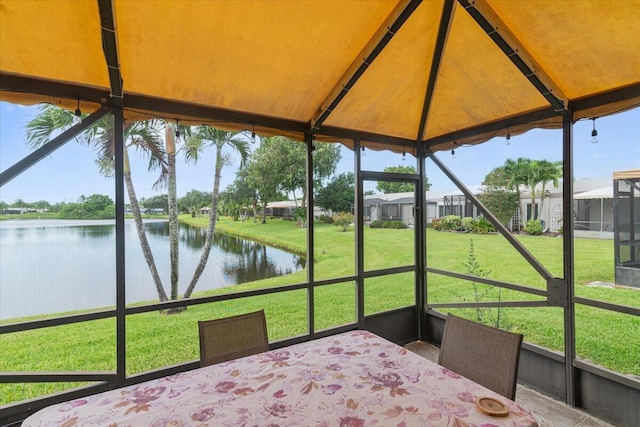 unfurnished sunroom featuring a water view