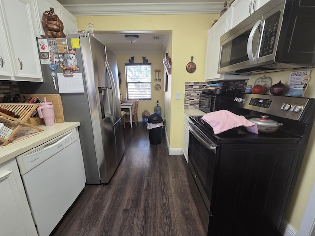 kitchen featuring white cabinetry, appliances with stainless steel finishes, dark wood-type flooring, and ornamental molding