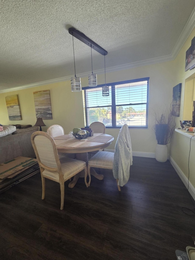 dining room with crown molding, a textured ceiling, and wood finished floors