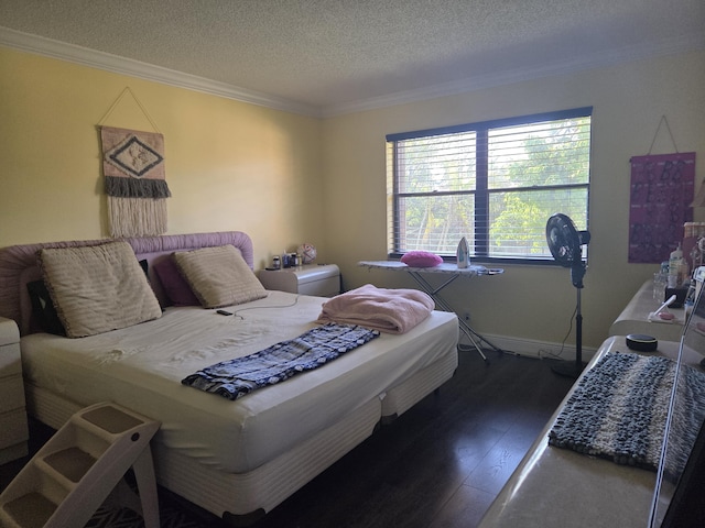 bedroom featuring crown molding, a textured ceiling, baseboards, and wood finished floors