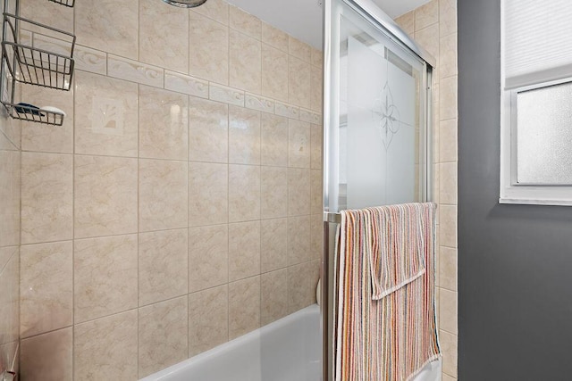 full bathroom with bath / shower combo with glass door