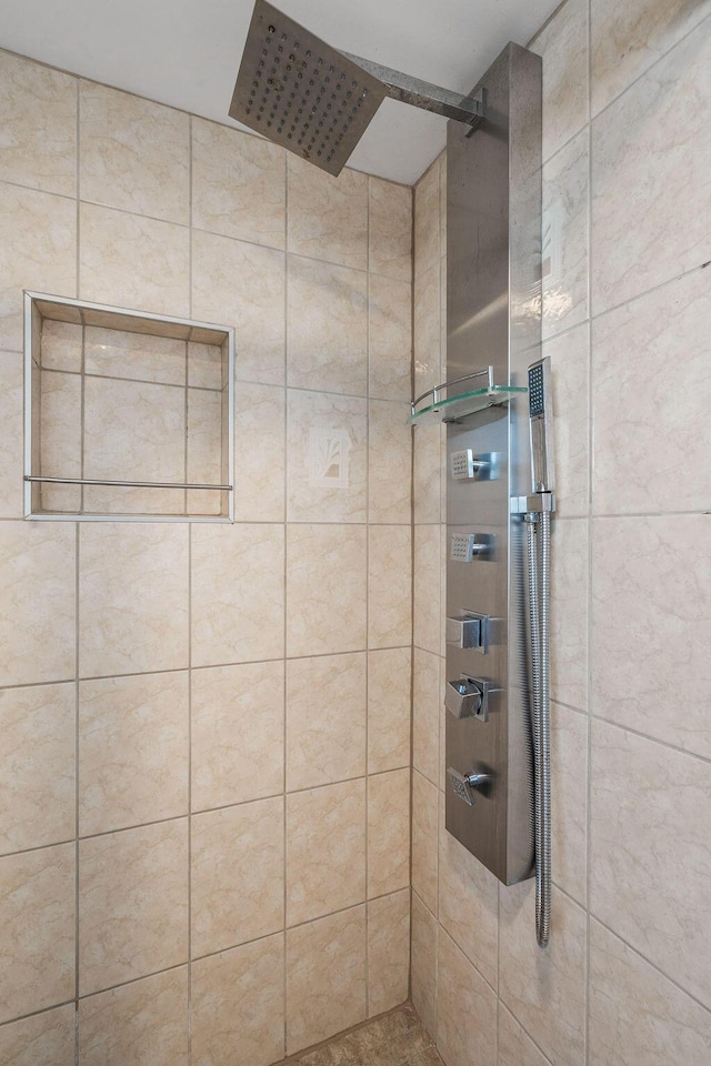 full bath with a tile shower