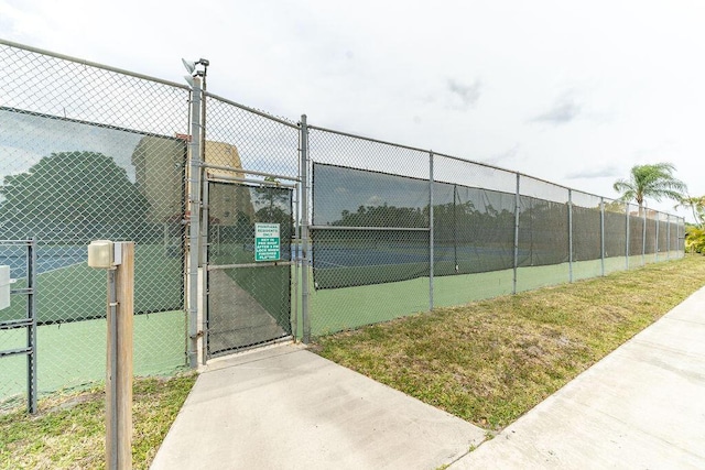 view of sport court featuring a gate and fence