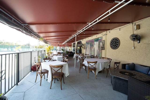 view of patio featuring outdoor dining space and a balcony