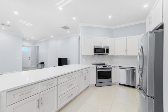 kitchen with crown molding, visible vents, stainless steel appliances, and backsplash