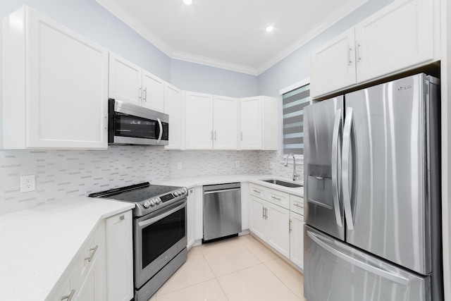 kitchen with a sink, stainless steel appliances, crown molding, backsplash, and light tile patterned flooring