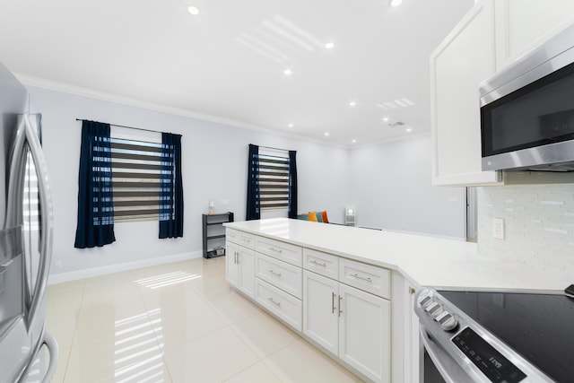 kitchen with appliances with stainless steel finishes, crown molding, a peninsula, and tasteful backsplash