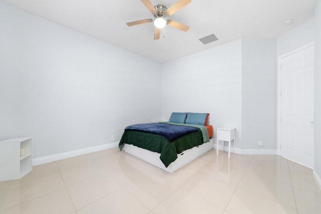 bedroom with light tile patterned floors, visible vents, and baseboards