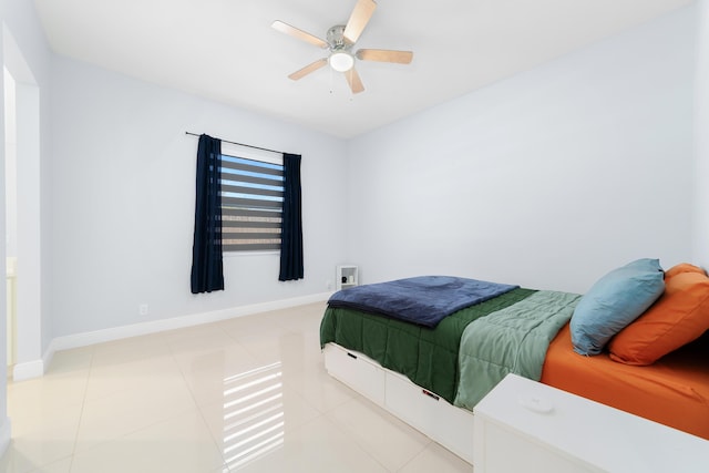 bedroom with tile patterned flooring, baseboards, and a ceiling fan