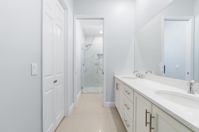 full bath featuring double vanity, tile patterned flooring, a sink, and a marble finish shower