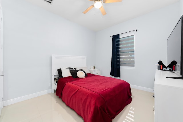 bedroom with light tile patterned floors, ceiling fan, and baseboards