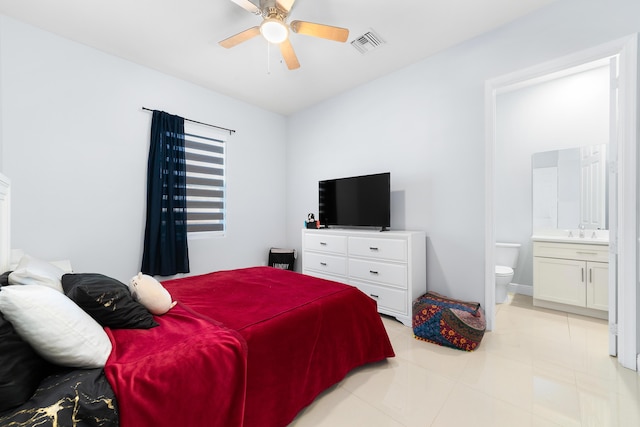 bedroom with ensuite bathroom, ceiling fan, a sink, and visible vents