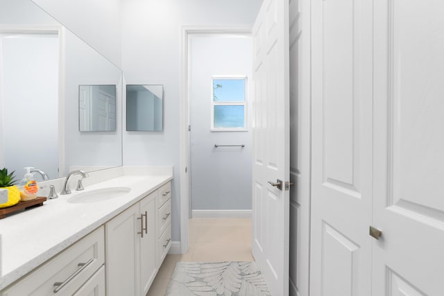 bathroom featuring vanity, baseboards, and tile patterned floors