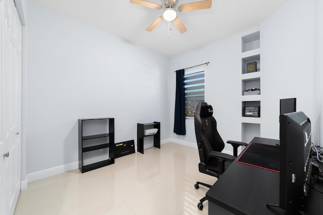 office area featuring ceiling fan, baseboards, and tile patterned floors