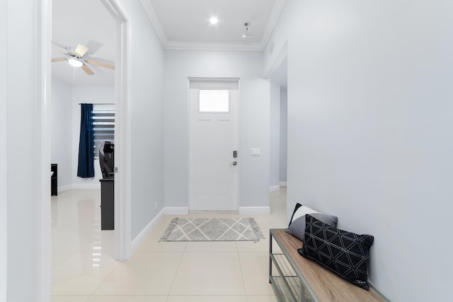 foyer entrance featuring light tile patterned floors, ceiling fan, baseboards, and crown molding