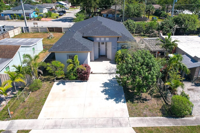 view of front of property with roof with shingles and stucco siding