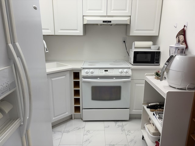 kitchen featuring white appliances, white cabinets, marble finish floor, light countertops, and under cabinet range hood