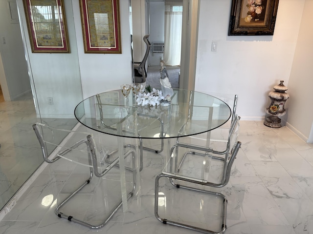 dining area featuring marble finish floor, cooling unit, and baseboards