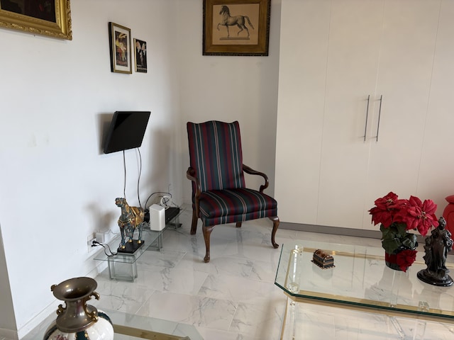 sitting room with marble finish floor