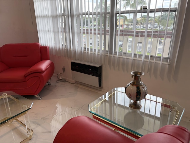 living room featuring marble finish floor and heating unit