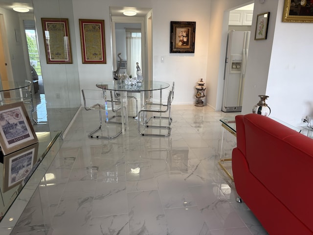 dining area with marble finish floor and baseboards