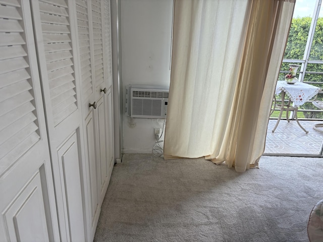 hall featuring light colored carpet and a wall mounted AC