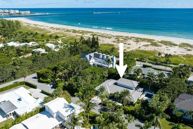 drone / aerial view with a water view and a beach view